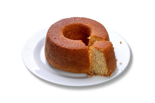 istock Cornmeal cake with cut slice on plate, isolated on white background. 1266282017