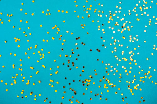 istock Light blue background with golden stars glitter 1266282142