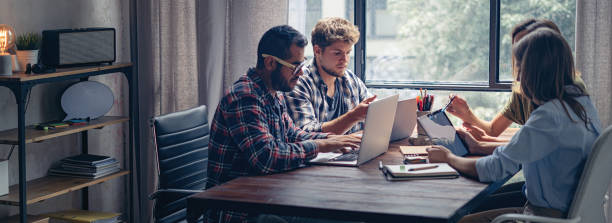 istock Group of young people working together. Creative business people in modern office. Hipster team in coworking. Young modern colleagues. 1266283473