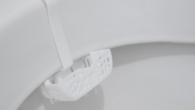Toilet air freshener holder in bowl 4K  tilting video