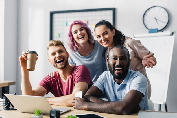 istock Selective focus of multiethnic business people looking at camera while working together in office 1266285158