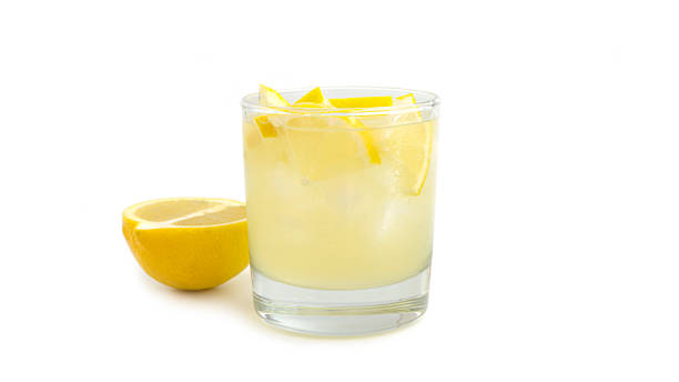 istock Glass with lemon lemonade and ice on a white background 1266285399