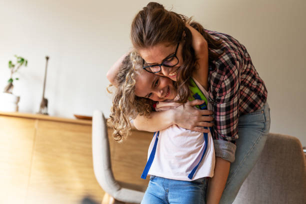 istock Mother preparing her daughter for first day in school. 1266286397