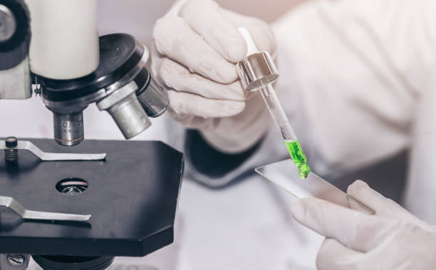 istock scientist with equipment and science experiments laboratory glassware containing chemical liquid. 1266288100