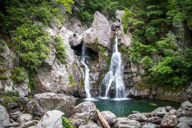istock Beautiful cascading waterfall over rocks 1266288844