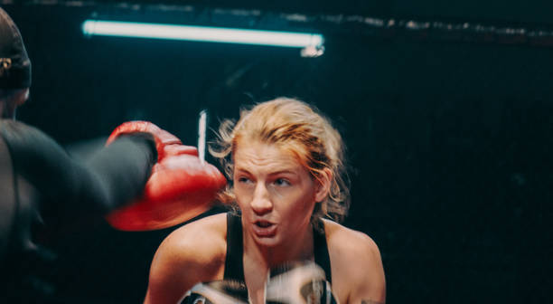 istock Female Boxer pad work session with trainer. Quick punch and dodge 1266293686