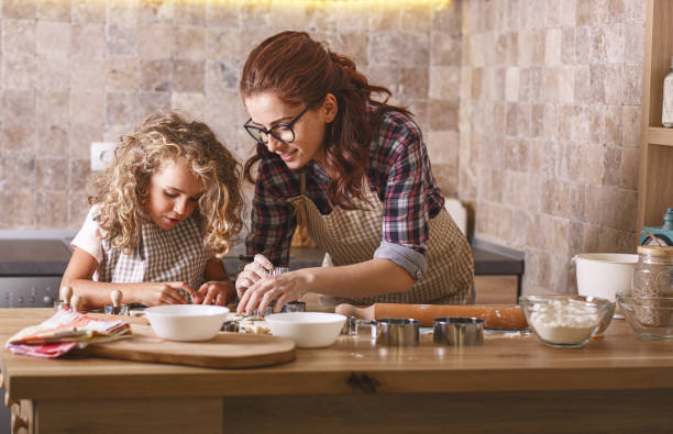 istock Mother and daughter playing and preparing dough in the kitchen. 1266295202