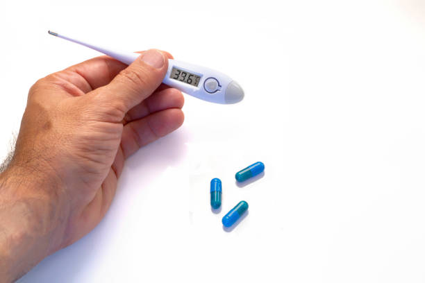 Thermometer on a red background.Flu epidemic, coronavirus. Temperature 37.2 C.