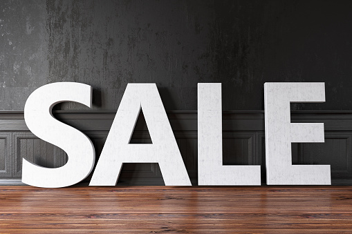 White Sale Sign Against Black Wall. 3d Render
