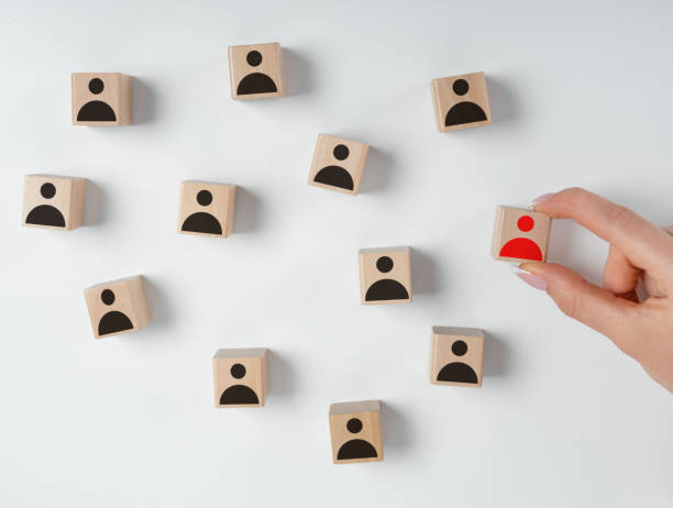 istock Wooden blocks with people icons 1266296152