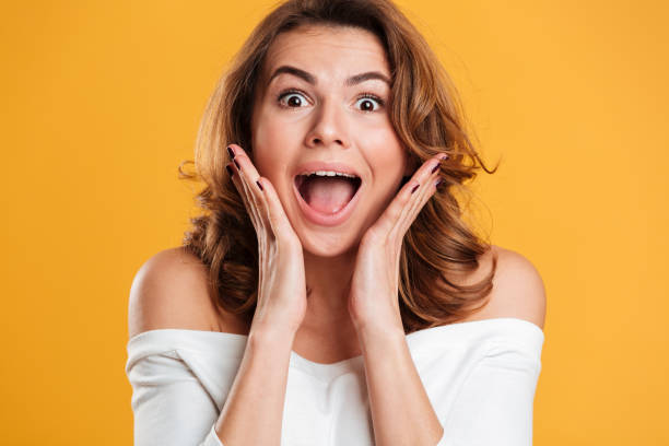 istock Shocked young woman standing isolated 1266296366