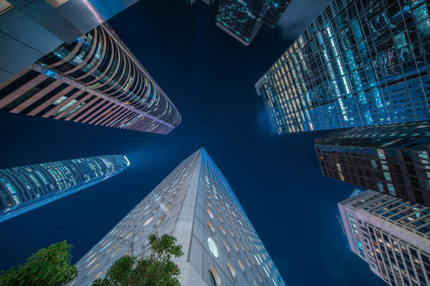 istock Directly below of modern buildings at night 1266296523