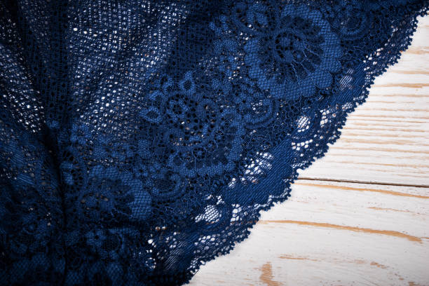 Dark blue antique lace napkin on white wooden background Dark blue antique lace napkin on white wooden background lacemaking photos stock pictures, royalty-free photos & images