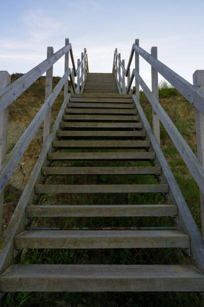 istock wooden steps heading down over the beach and sand dunes at Lowestoft Suffolk 1266298016