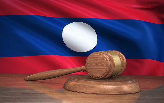 3d Render Judge Gavel and Laos flag on background (Close-up)