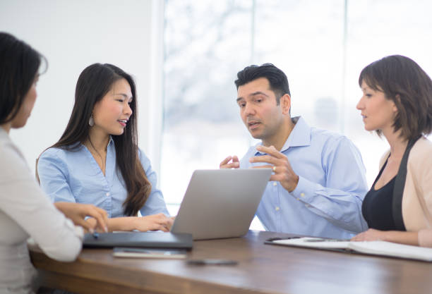 istock Businesspeople discussing with each other 1266299337