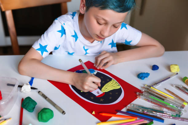 istock Child doing creative hand made work with color paper and plasticine. Kids crafts. 1266299454