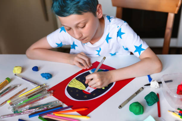 istock Child doing creative hand made work with color paper and plasticine. Kids crafts. 1266299462