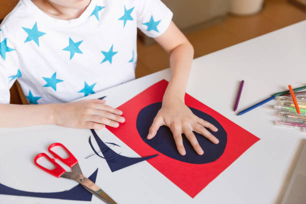 istock Child hands making hand made card. Kids art and crafts. 1266299582