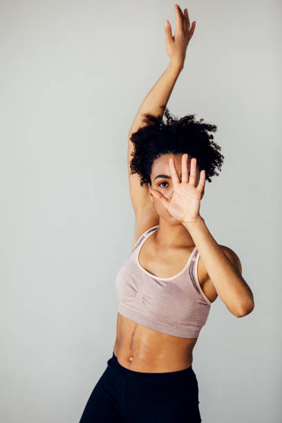 istock Young dancer hiding her face with hand in a small studio 1266301952