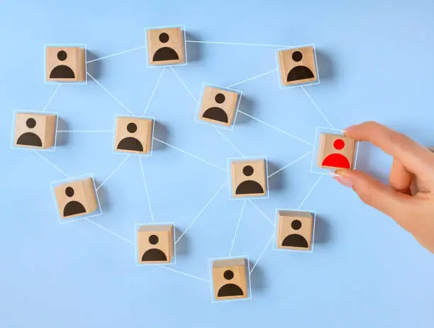 Wooden blocks with people icon on blue background