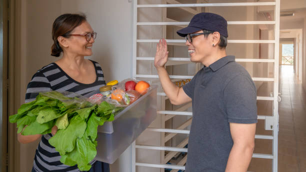 istock Door to door deliver cargo social distancing while virus is speading 1266305956