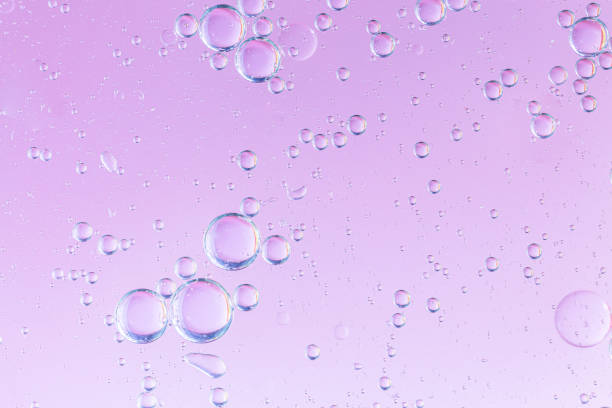 istock oil with bubbles on coral background. Pink Abstract space background. Soft selective focus. macro of oil drops on water surface. copy space. air bubbles in water, 1266306166