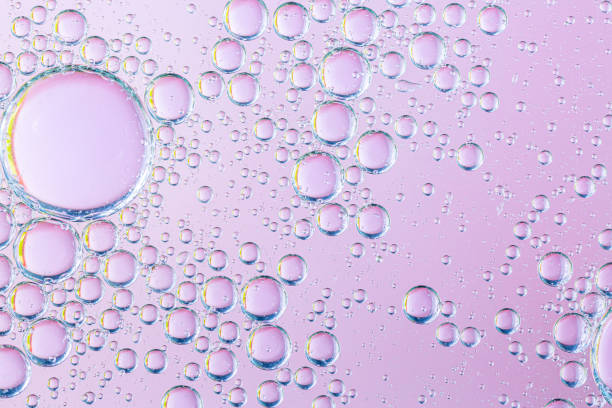 istock oil with bubbles on coral background. Pink Abstract space background. Soft selective focus. macro of oil drops on water surface. copy space. air bubbles in water, 1266306491