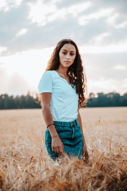istock Young woman inside in summer corn field at sunset 1266308874