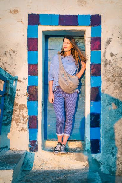 istock Woman posing at the blue, textured  wall 1266312278