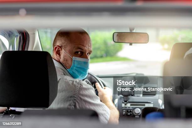 Man With Protective Mask In A Car Stock Photo - Download Image Now - Taxi Driver, Protective Face Mask, Car