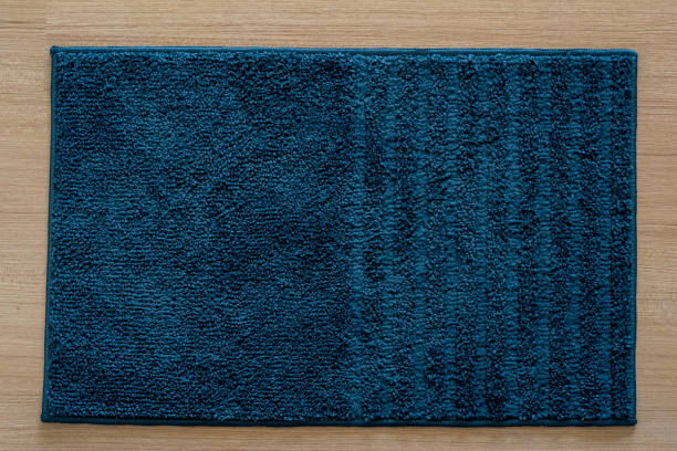 istock Moder blue doormat isolated on wood texture background 1266313510