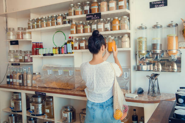 istock Young woman shopping in zero waste plastic free store with reusable mesh bag. Low waste lifestyle. Sustainable eco lifestyle 1266313832