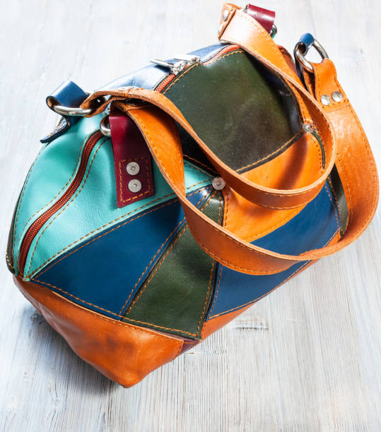 istock patchwork leather travel bag on wooden table 1266315228