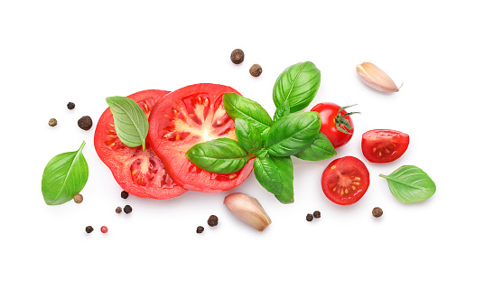 Ingredients for cooking, garlic, tomatoes, spices and herbs isolated on white background. Top view.
