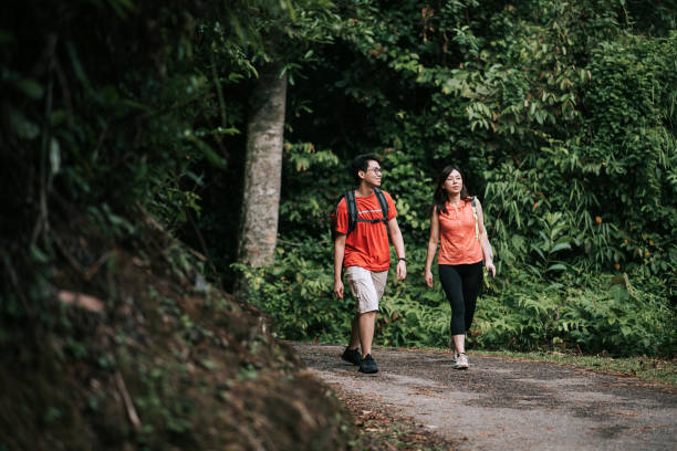 istock Two asian chinese friends exploring and walking in the jungle 1266316219