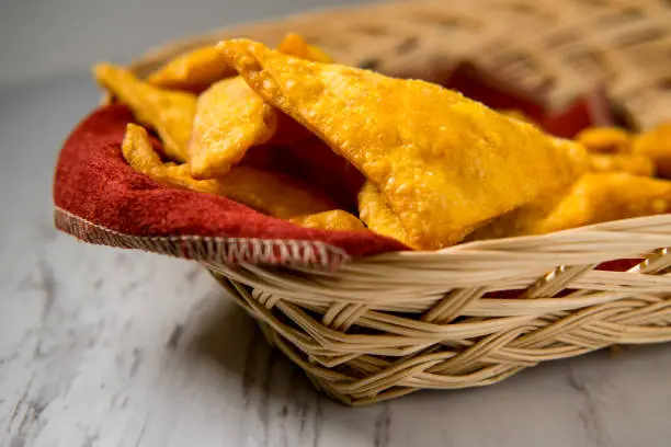 Chinese cheese wontons appetizer at restaurant served in wicker basket