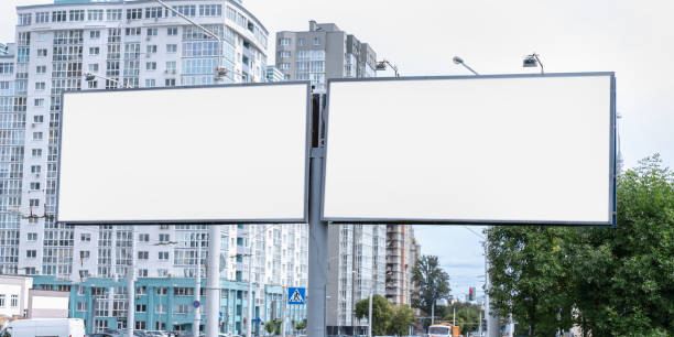 two big white empty billboards on pole at city street commercial advertising concept - billboard bill city advertise imagens e fotografias de stock