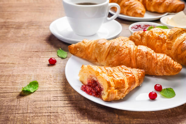 istock Delicious breakfast with fresh croissants 1266318423