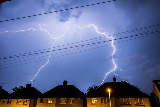 Lightning Storm in Night Sky Above Houses Lightning Storm in the Night Sky Above Residential Houses in Essex, UK. lightning thunderstorm electricity cloud stock pictures, royalty-free photos & images