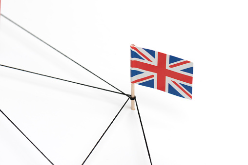 British  flag connected with a black strings and is part of a graph of strings on white background.