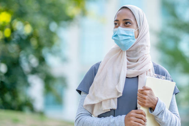 istock Beautiful Muslim Doctor Standing Outside 1266322820