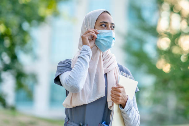 istock Beautiful Muslim Doctor Standing Outside 1266322823
