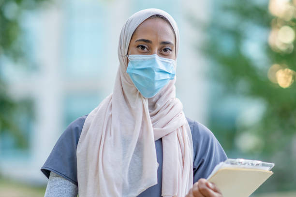 istock Beautiful Muslim Doctor Standing Outside 1266322824