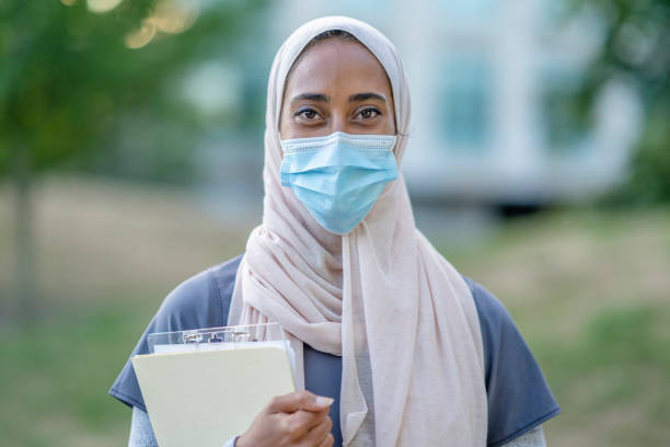 istock Beautiful Muslim Doctor Standing Outside 1266322825