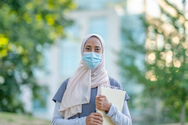 istock Beautiful Muslim Doctor Standing Outside 1266322828