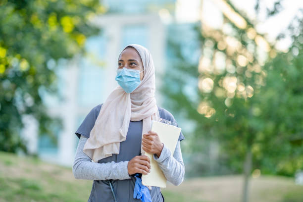 istock Beautiful Muslim Doctor Standing Outside 1266322847