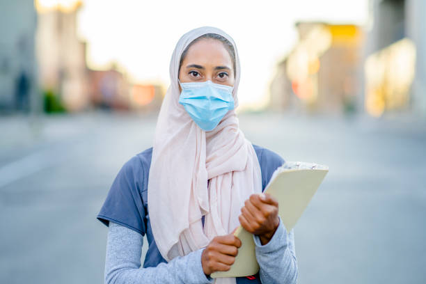 istock Beautiful Muslim Doctor Standing Outside 1266322874