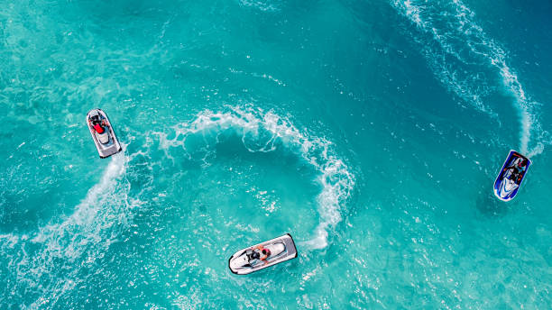 Jet Ski, Tropical Ocean Aerial view Aerial view of Jet Ski, Tropical Ocean Maldives island summer vacation atoll photos stock pictures, royalty-free photos & images