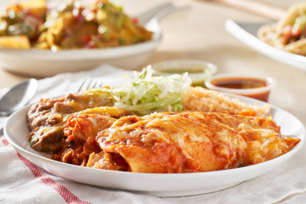istock mexican enchilada platter with red sauce, refried beans and rice 1266325184